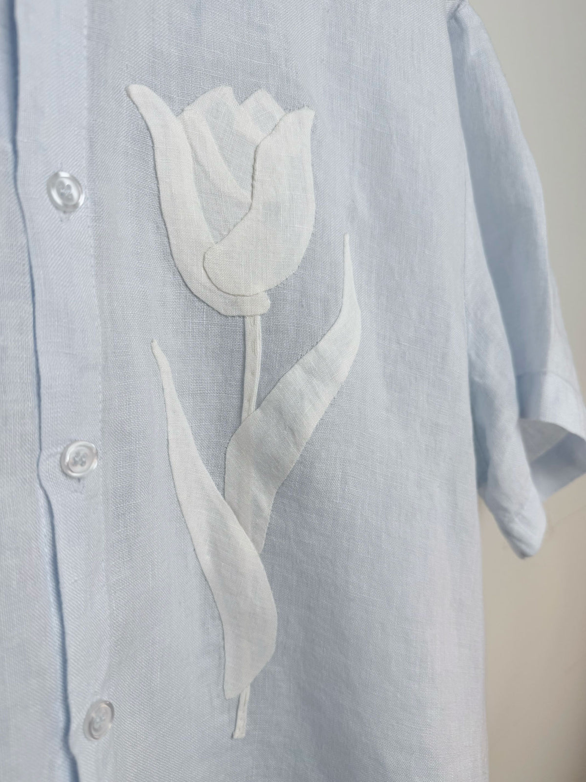 Light blue linen shirt with a tulip appliqué design